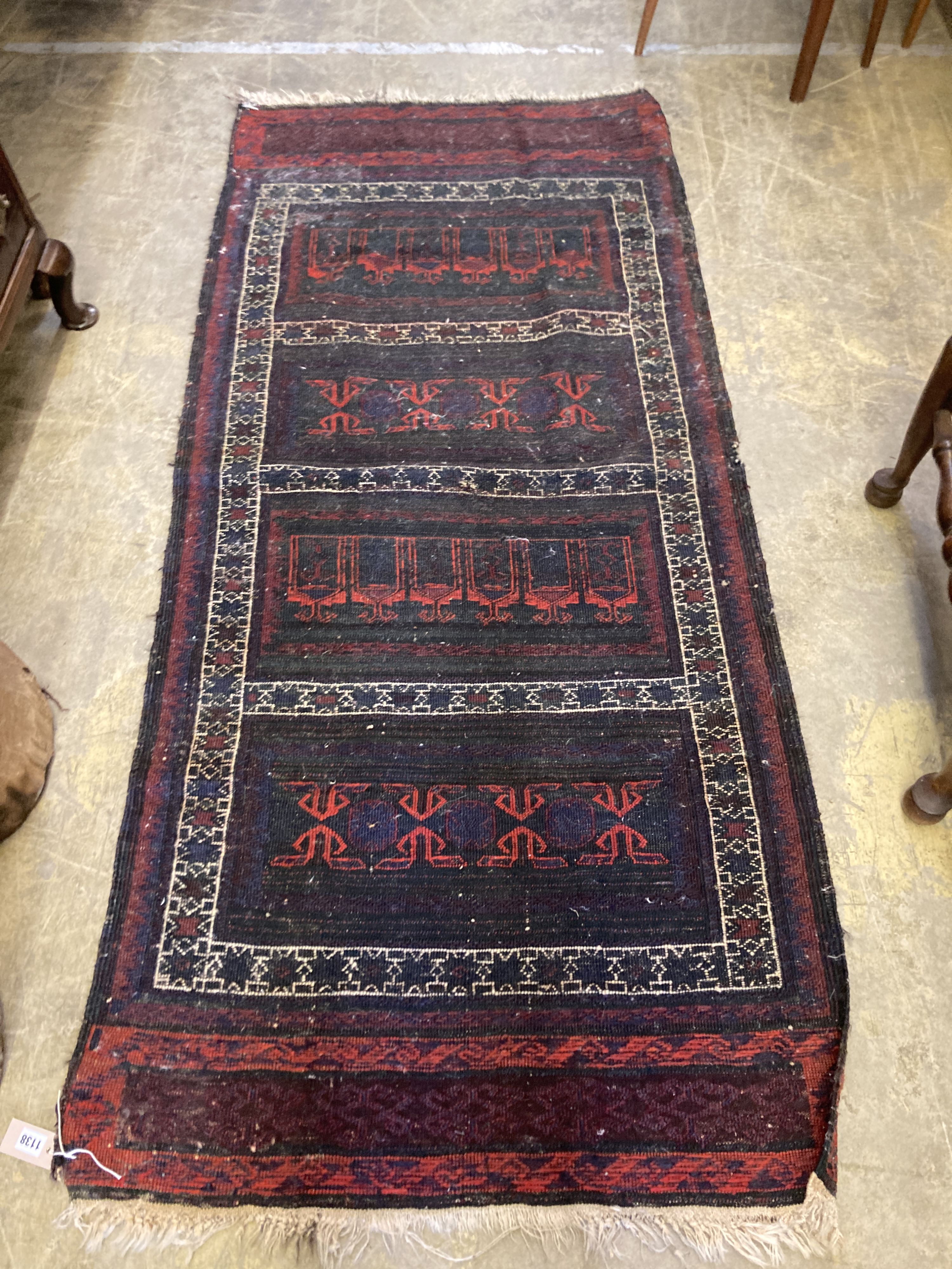 An Afghan red ground rug with stylised mihrab and iris motifs, a small Afghan rug and three carpet panel cushion covers, largest 200 x